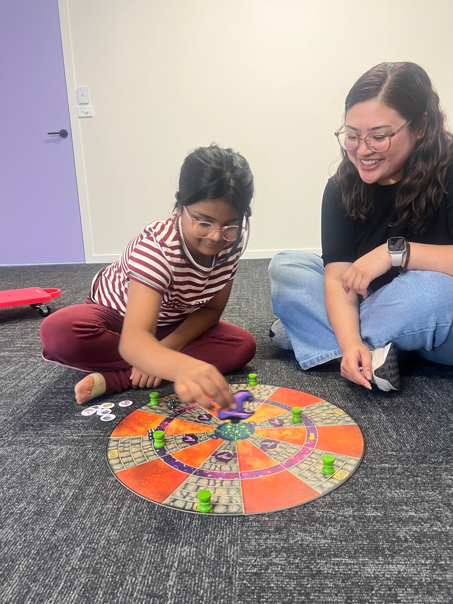 Therapist and child enjoying a board game
