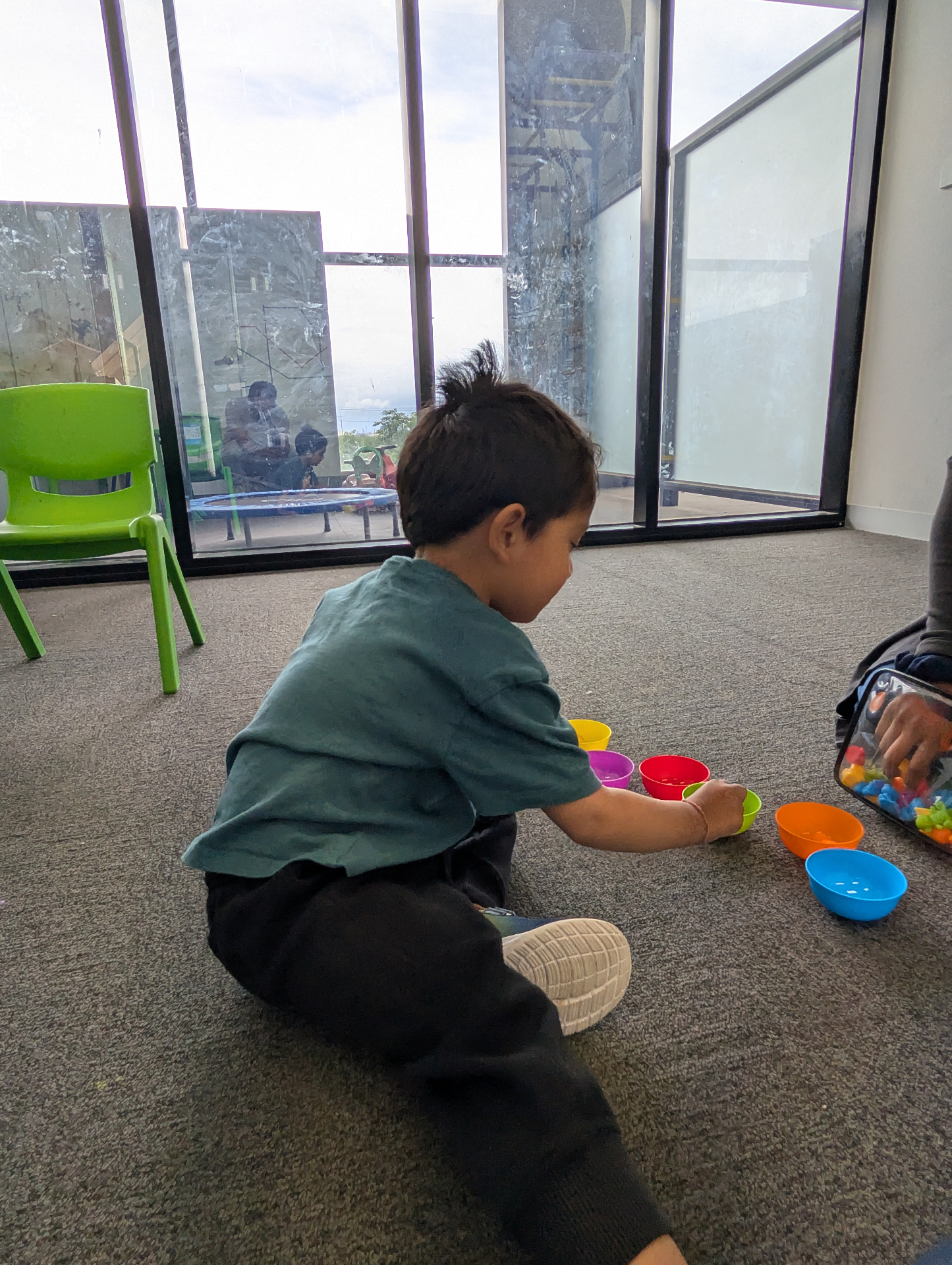 Therapist and child high-fiving