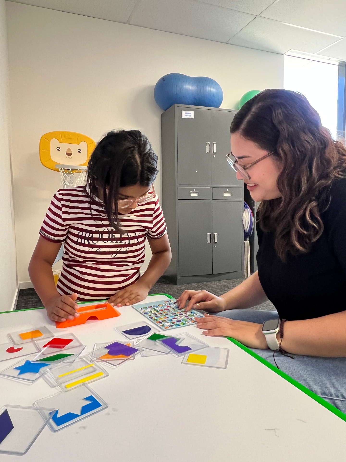 Therapist helping child with shape matching