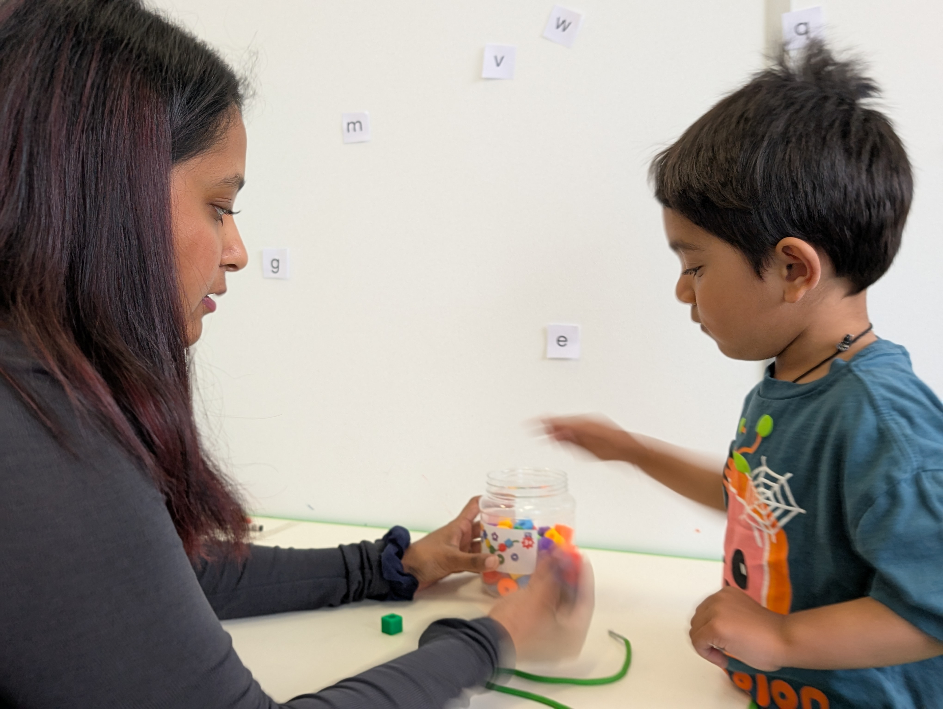 Therapist and child with therapy materials