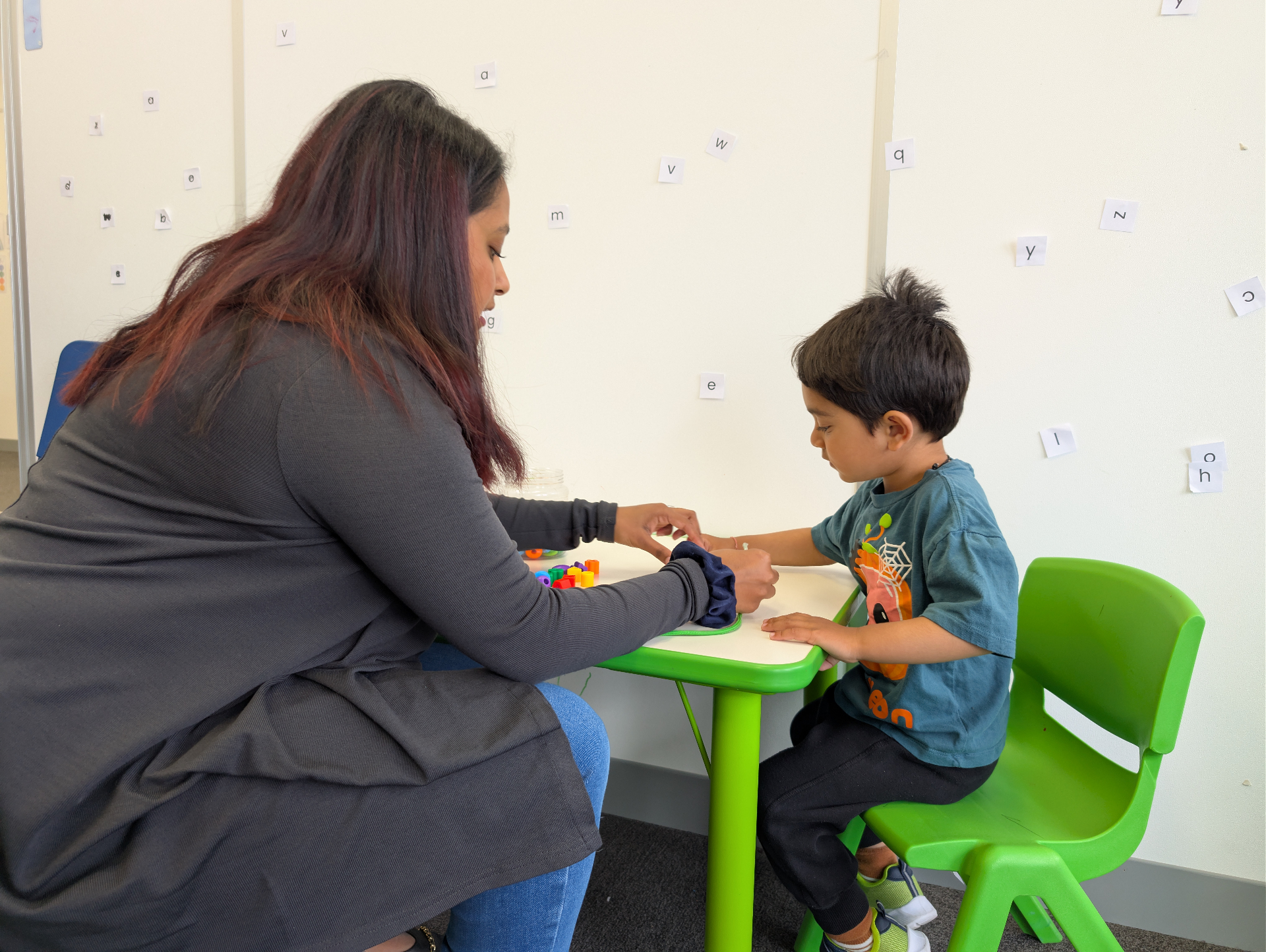 Therapist and child working with letter cards