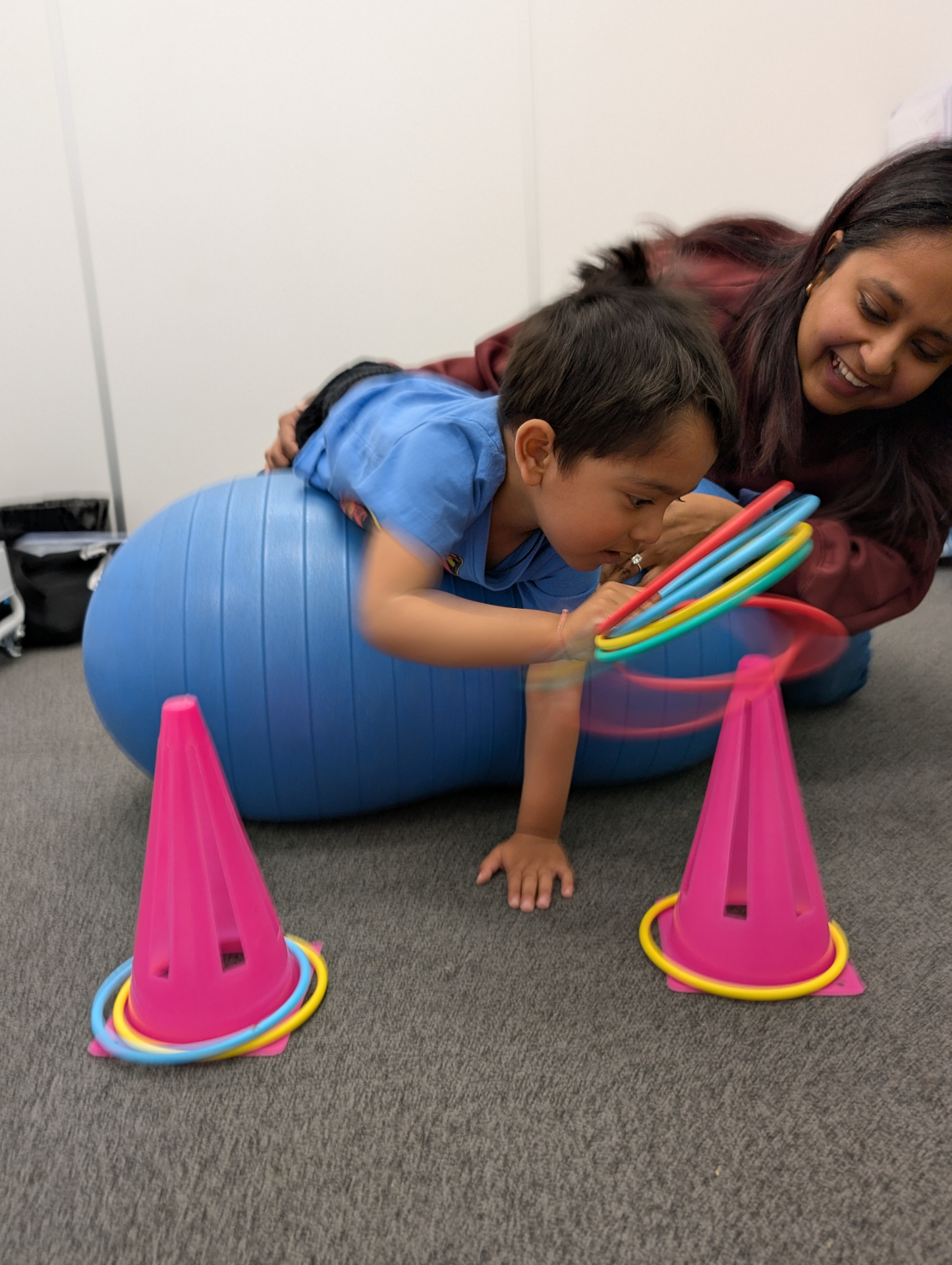 Child on therapy ball reaching